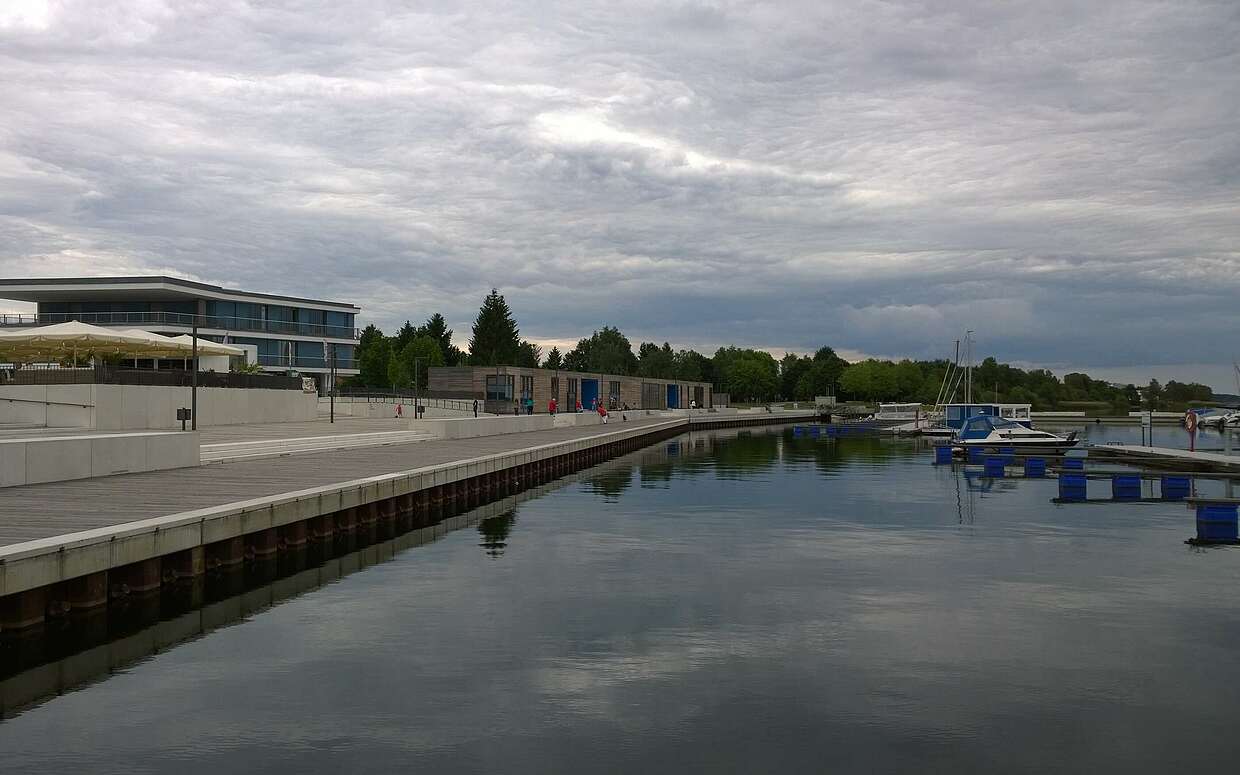 Bei trübem Wetter nicht überlaufen: Blick auf den neuen Stadthafen und die Uferpromenade am Senftenberger See