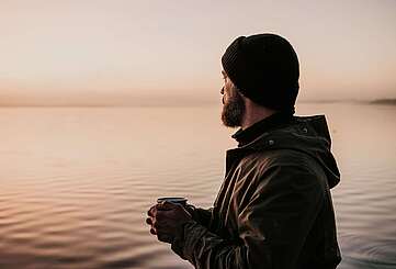 Mann auf Steg am Morgen